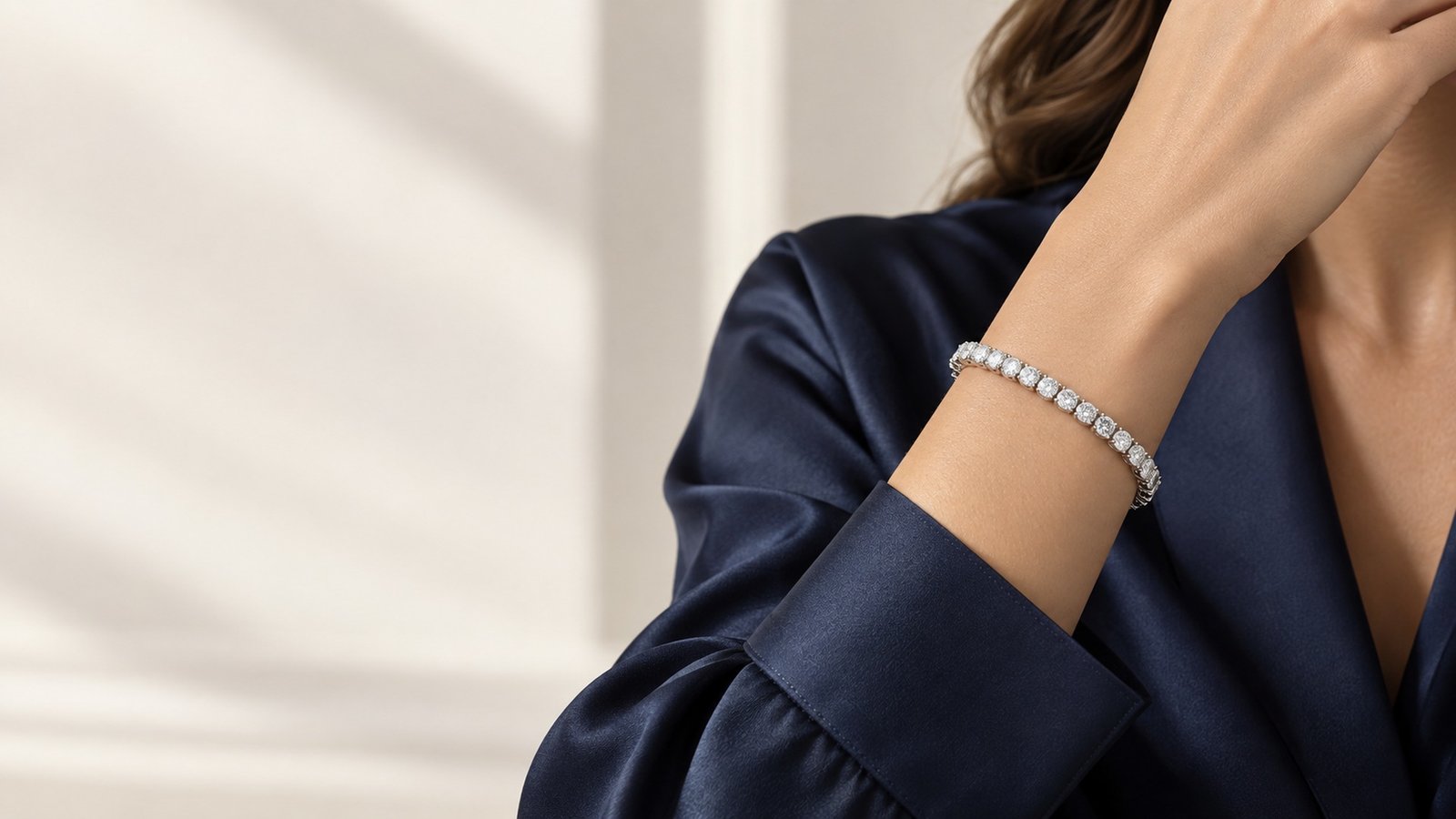 Classic moissanite tennis bracelet worn with a deep navy silk cuff