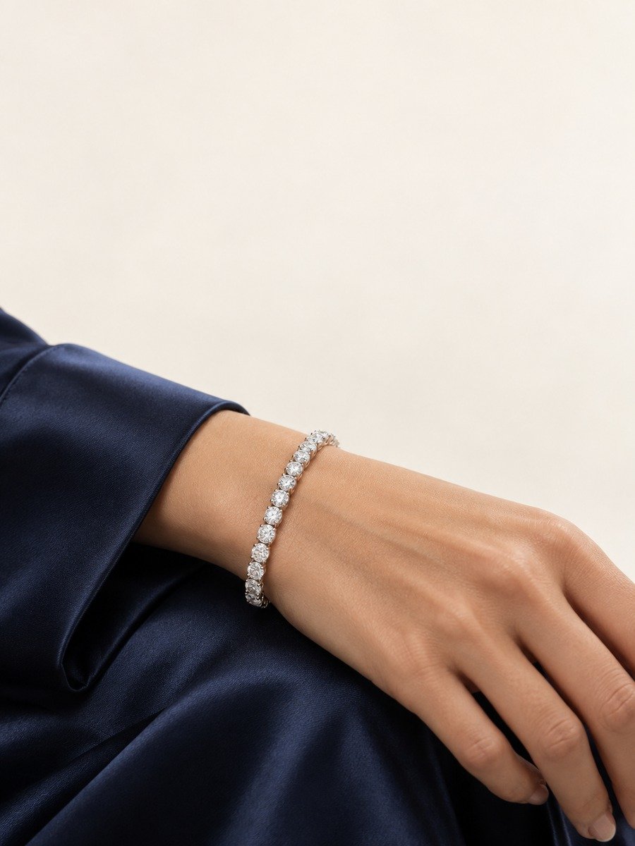 Classic moissanite tennis bracelet worn with a deep navy silk cuff